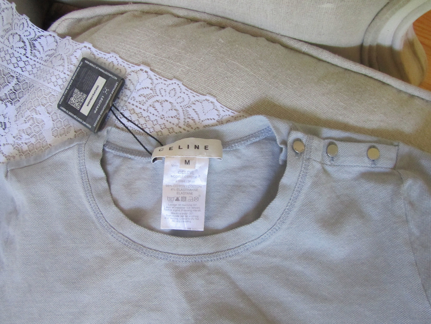 Light-colored shirt with a tag on a textured surface
