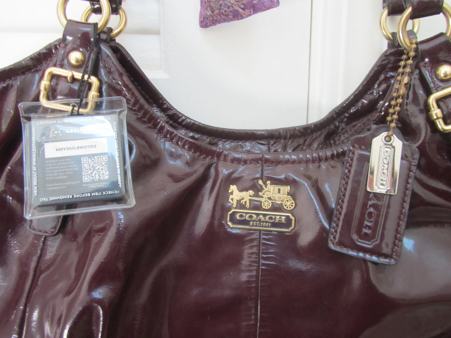 Brown Coach handbag with gold hardware and visible brand logo.