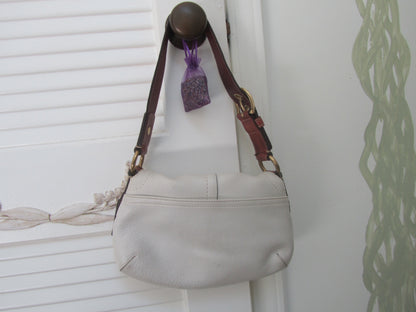 Light gray handbag with a brown strap on a white background