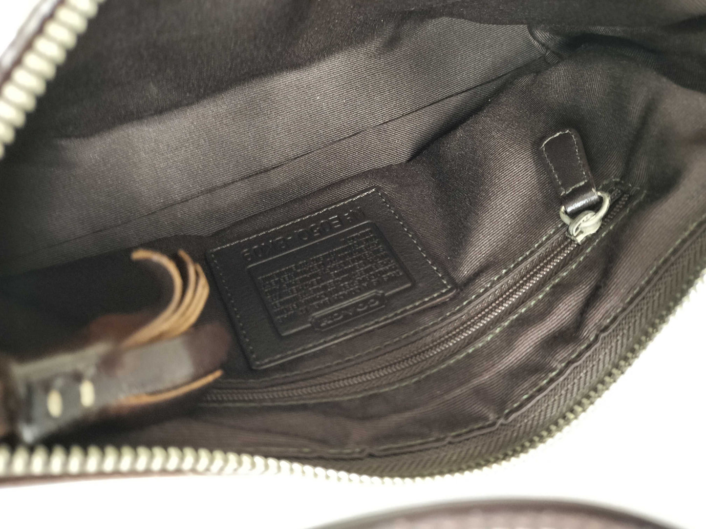 Close-up of a bag with a visible brand label on a white background