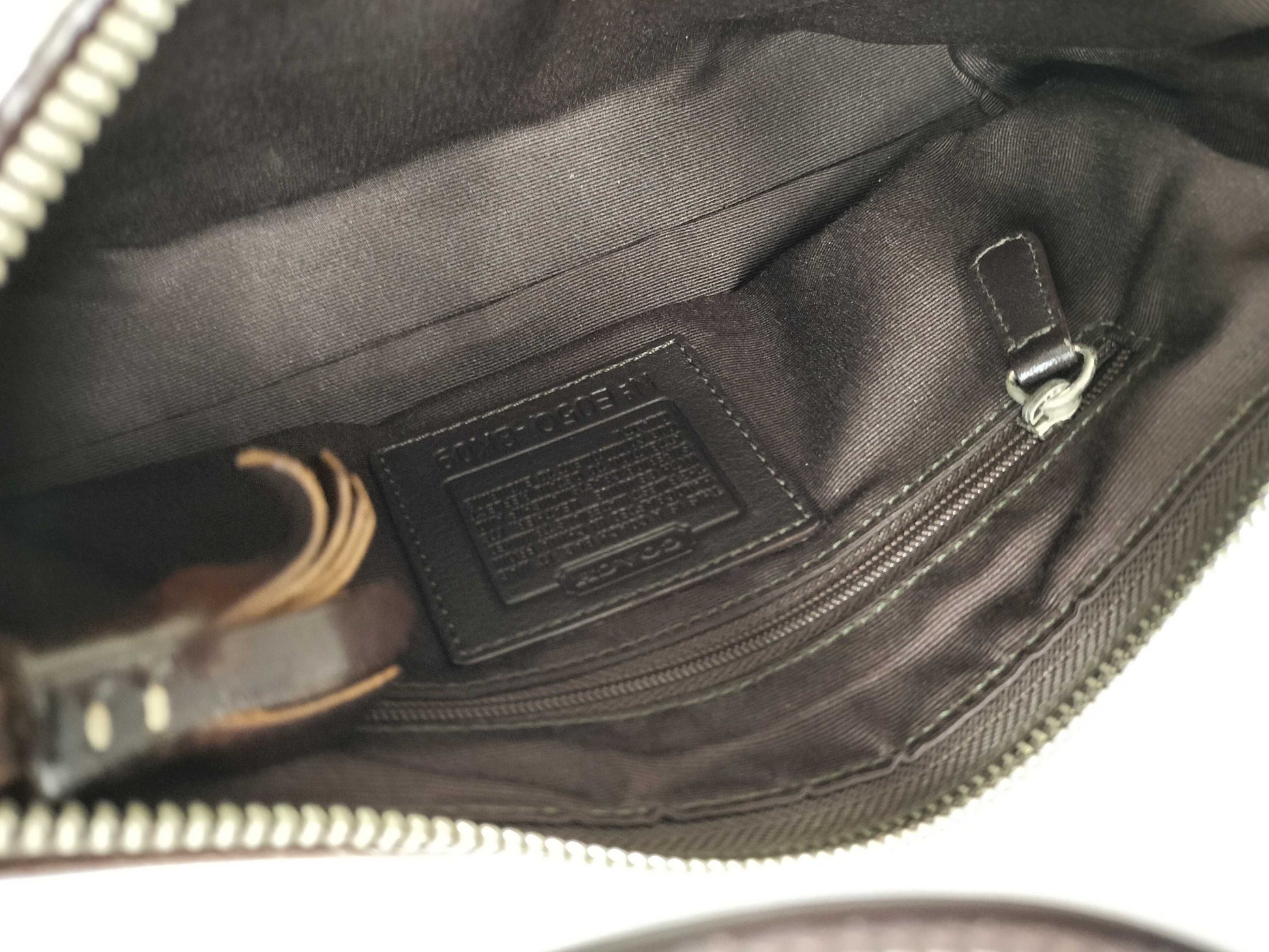Close-up of a bag with a visible brand label on a white background