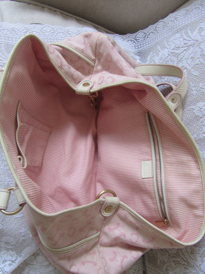 Pink handbag with floral pattern on a textured surface