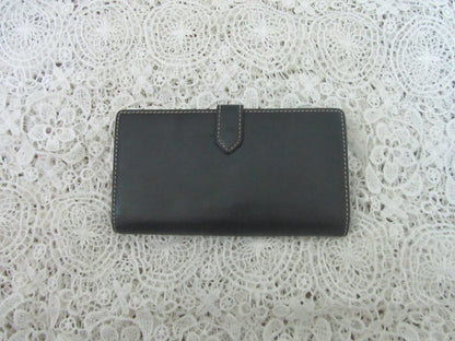 Black wallet on a white lace background