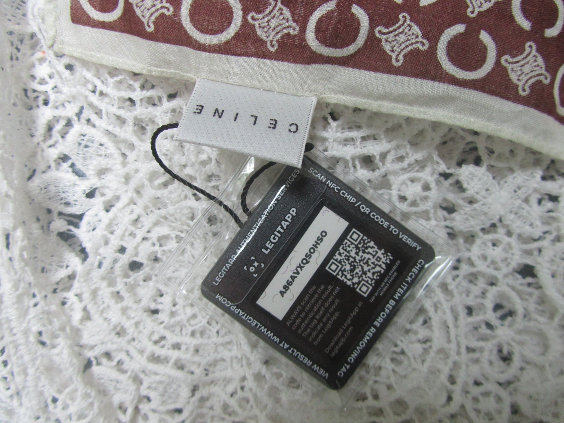 Close-up of a Celine tag on a textured white surface