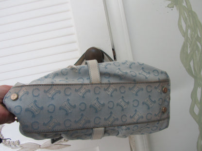 Patterned bag held by a hand against a white background