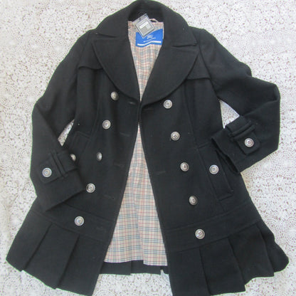 Black coat with silver buttons on a textured surface