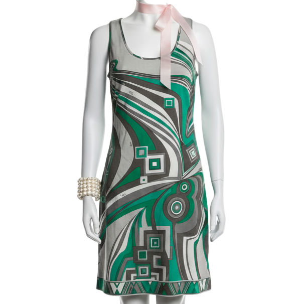 Mannequin wearing a green and gray patterned dress on a white background