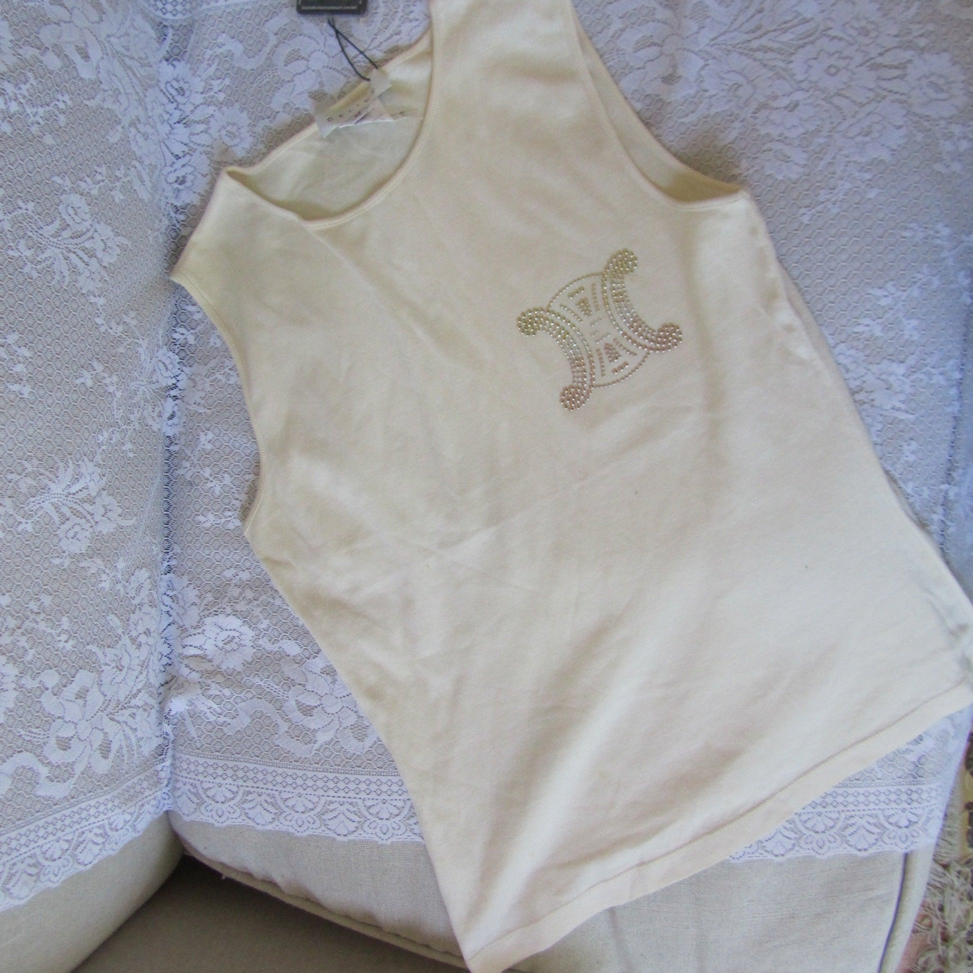 Beige baby top with a design on a lace tablecloth