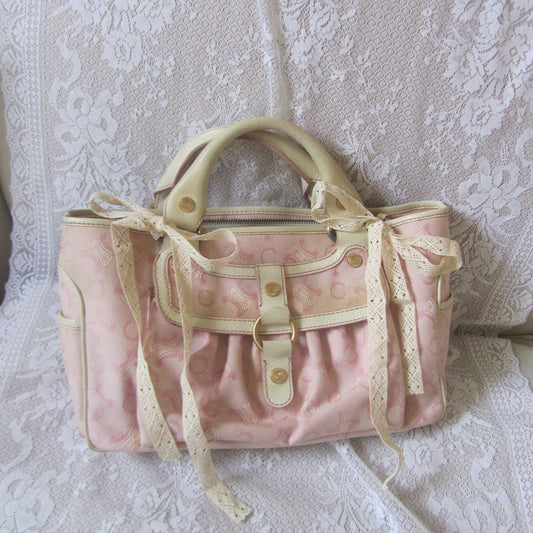 Pink patterned bag on a textured white surface