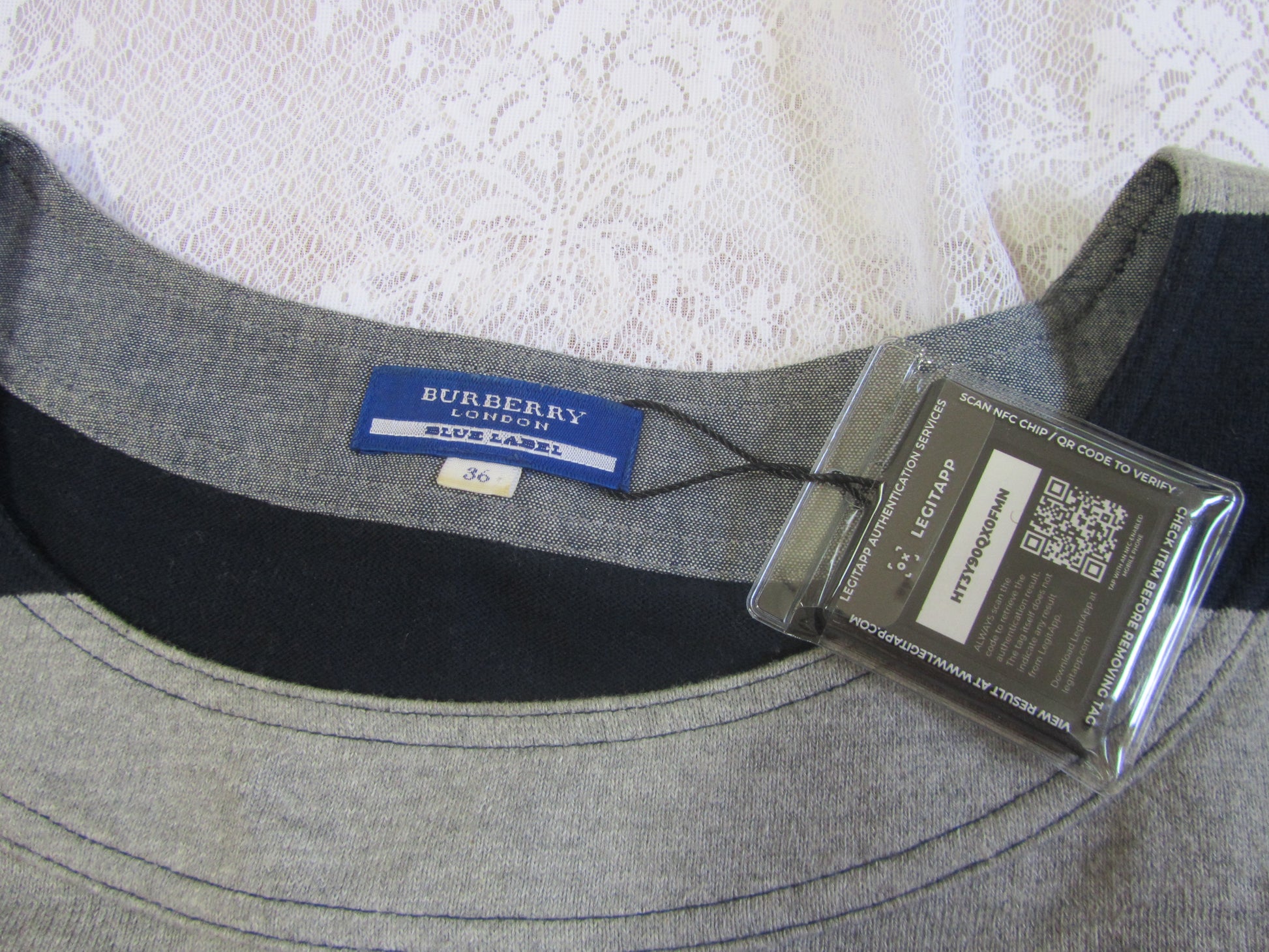 Gray Burberry shirt with a tag on a textured white background