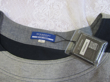 Gray Burberry shirt with a tag on a textured white background