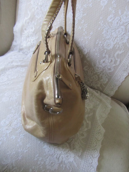Beige handbag on a white lace fabric background