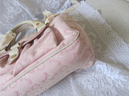 Pink bag with a bow on a lace surface