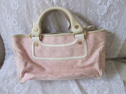 Pink patterned bag on a textured white surface