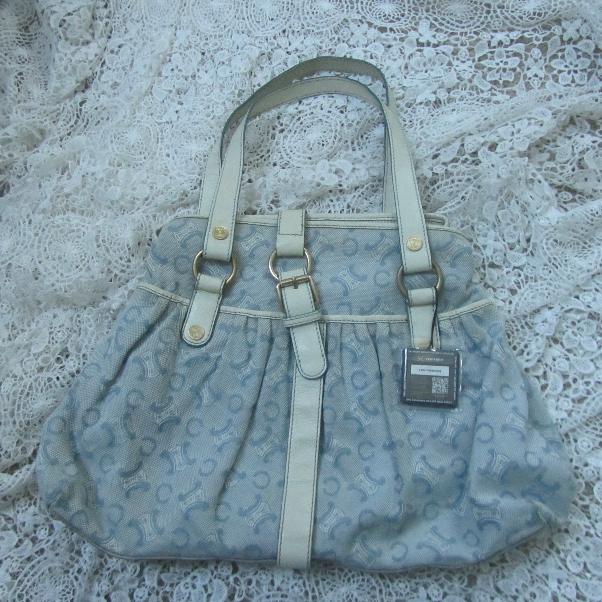 Light blue handbag with a pattern on a lace surface