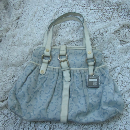 Light blue handbag with a pattern on a lace surface