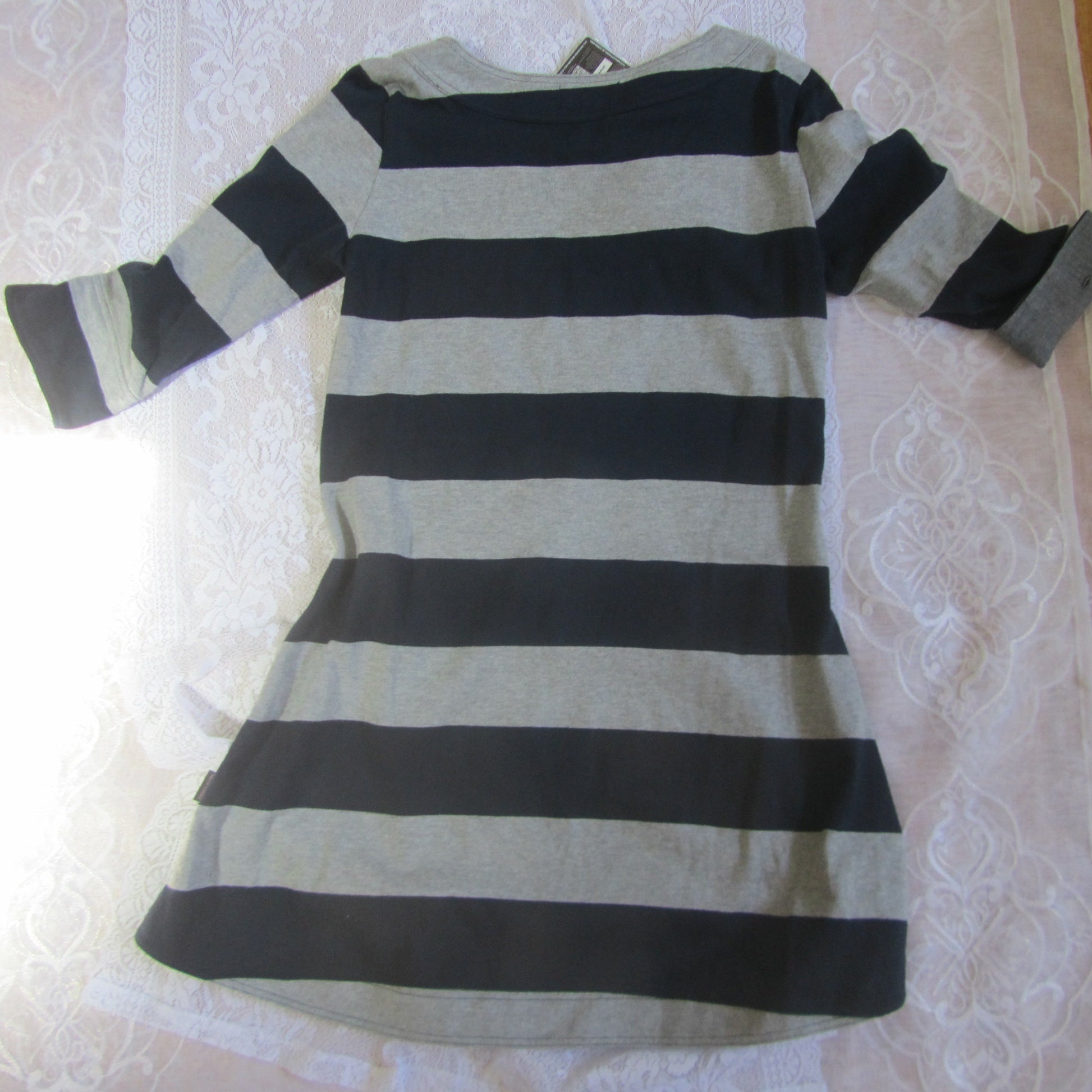 Black and white striped dress on a white lace tablecloth