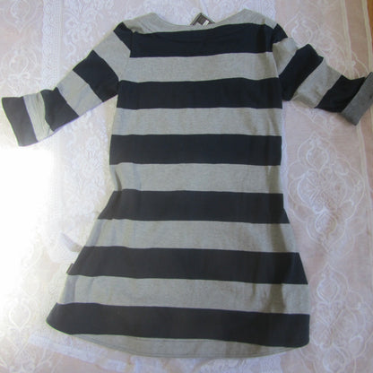 Black and white striped dress on a white lace tablecloth