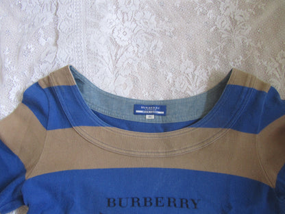 Blue and beige Burberry shirt on a textured white background