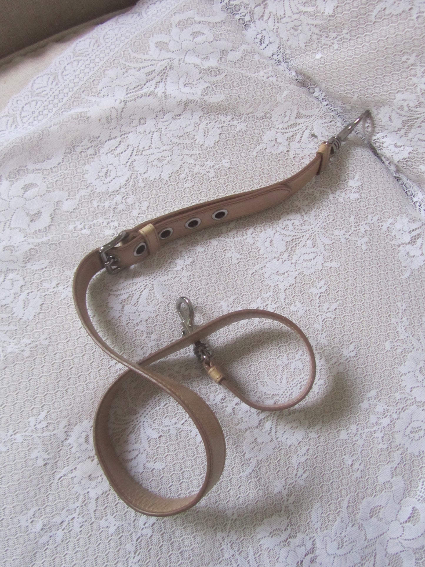 Brown leather chain on a textured white surface