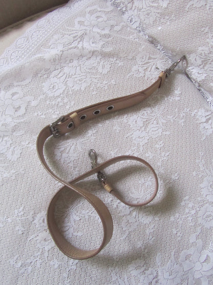 Brown leather chain on a textured white surface