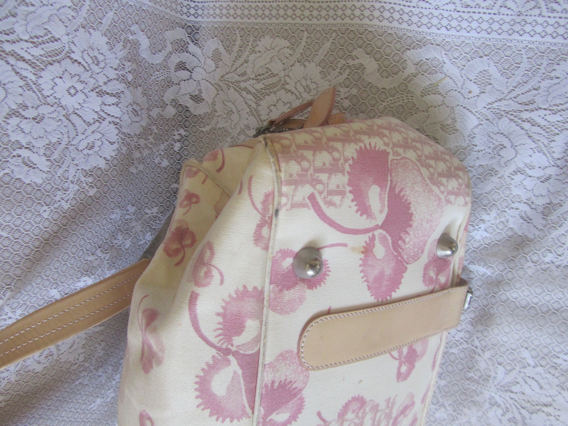 Pink and beige patterned bag on a textured white background