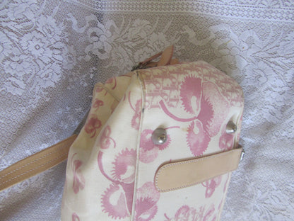 Pink and beige patterned bag on a textured white background