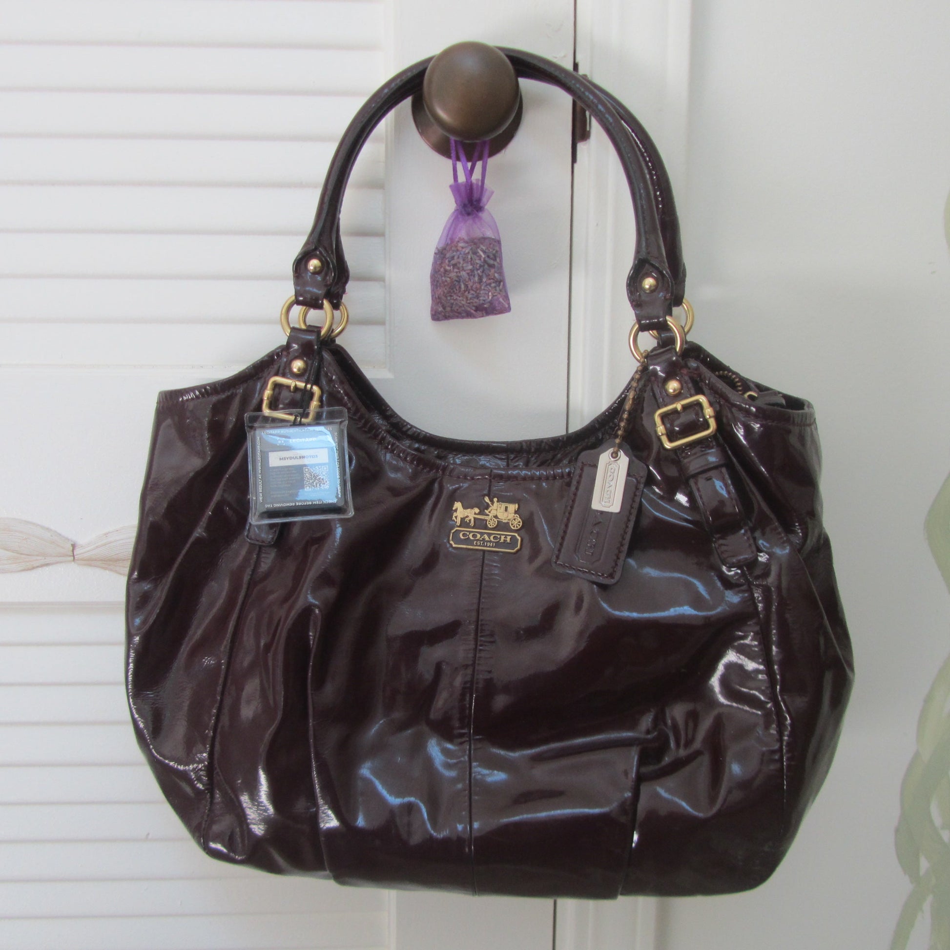 Brown handbag with a tag on a white background