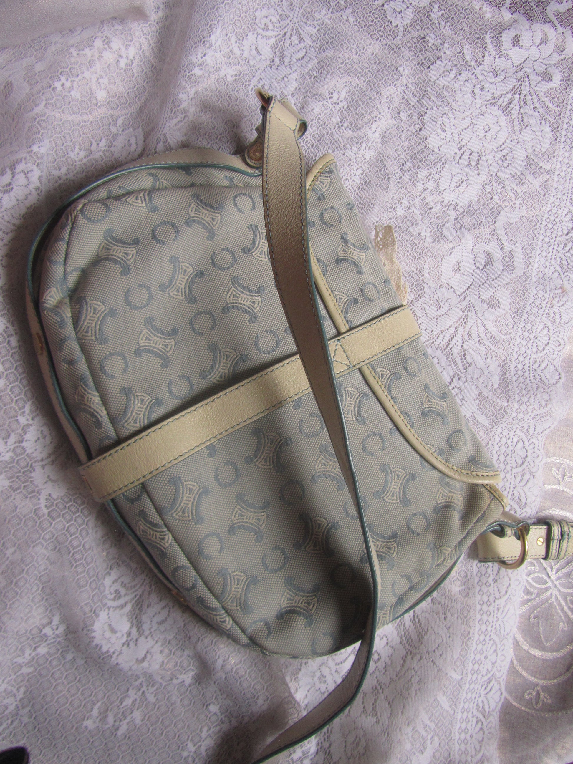 Light blue handbag with lace details on a textured white background