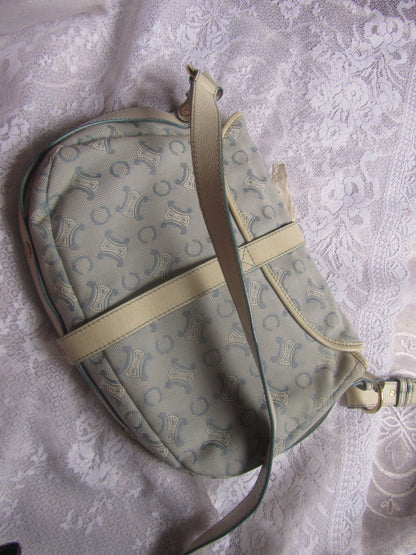 Light blue handbag with lace details on a textured white background