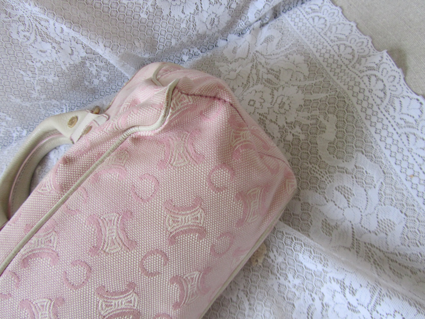 Pink patterned bag on a textured white surface