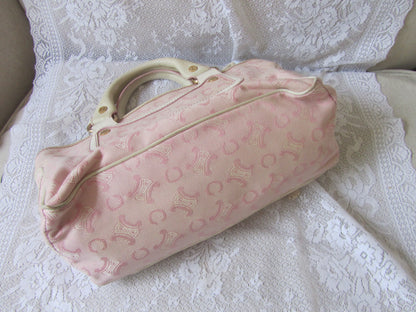 Pink patterned bag on a white lace fabric background