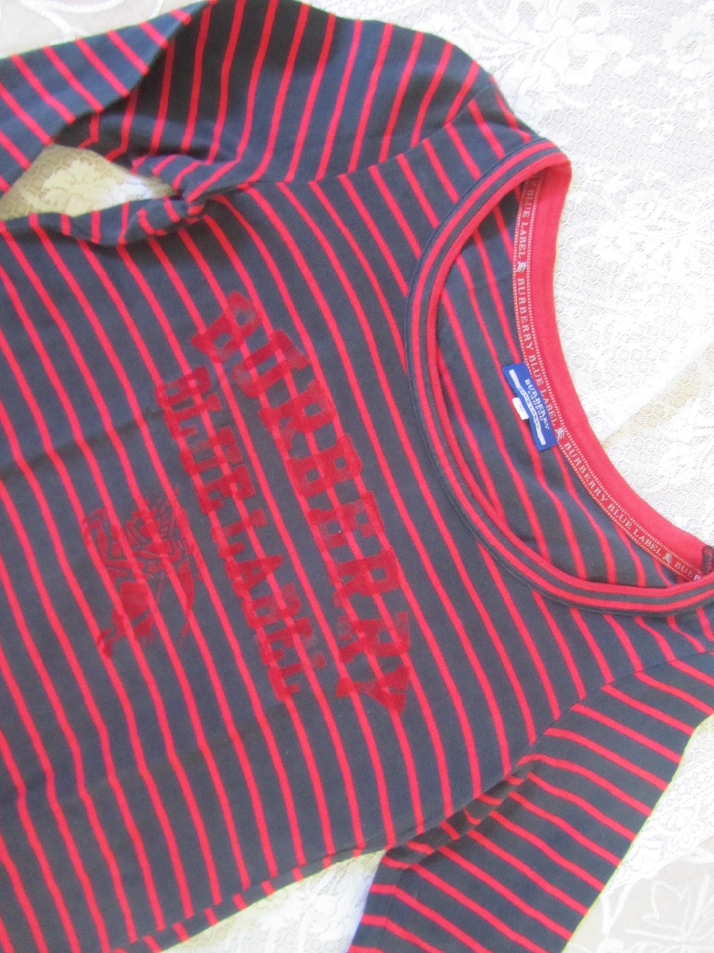 Red and gray striped shirt with text on a white background
