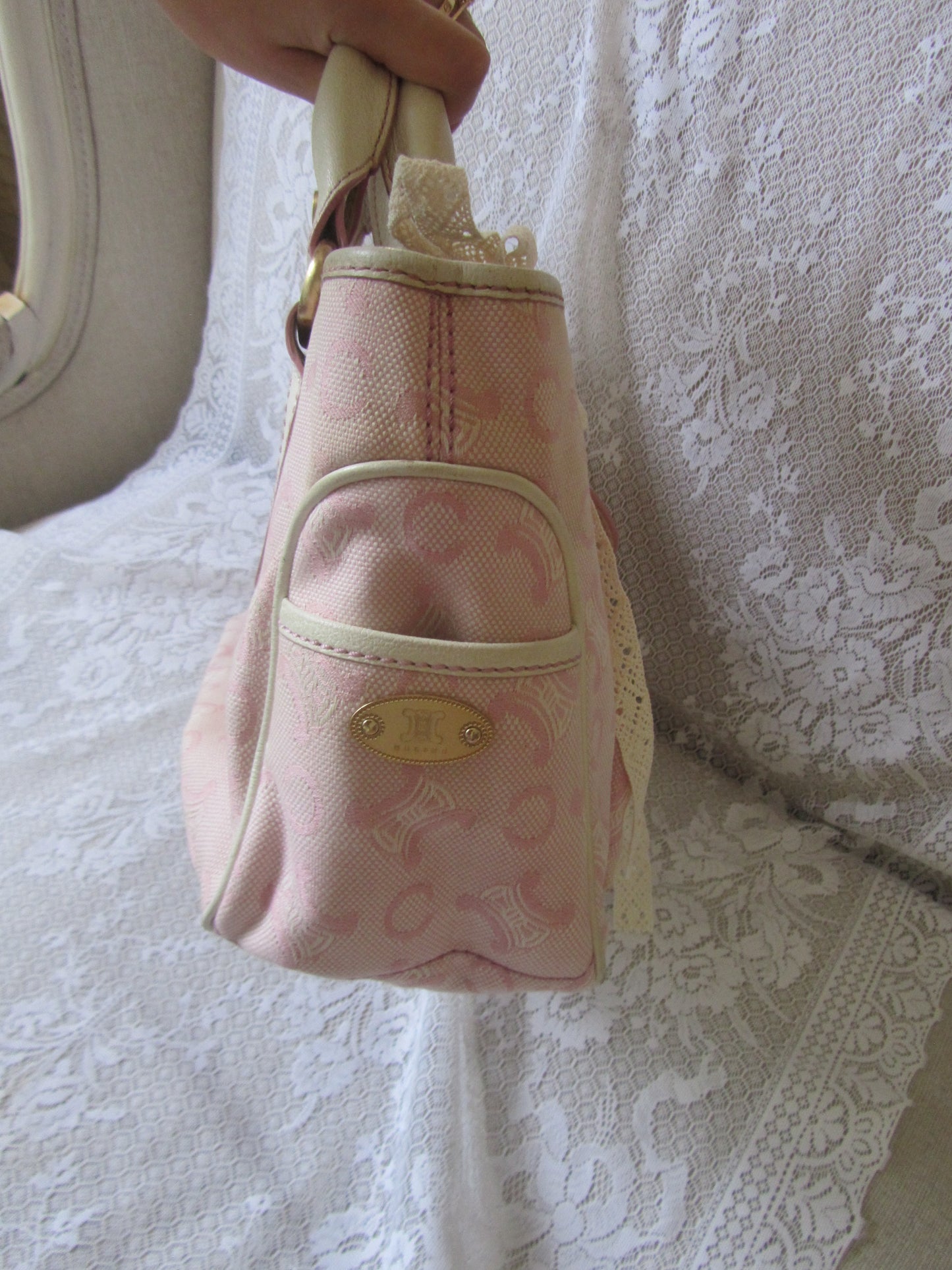 Pink patterned bag on a textured white surface
