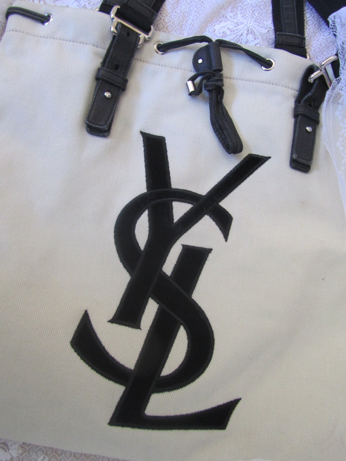 Black leather straps on a beige background