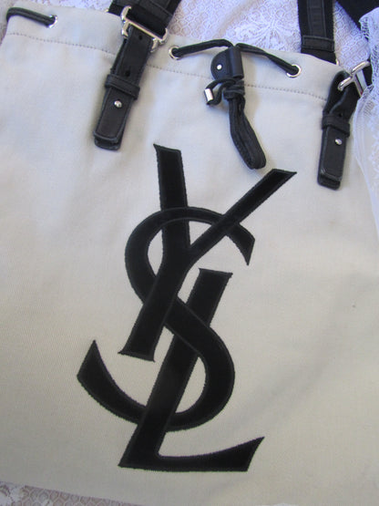 Black leather straps on a beige background