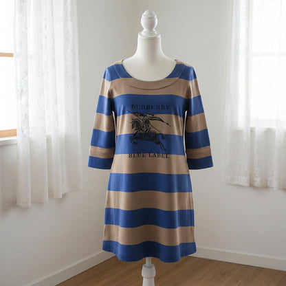 Striped dress on a mannequin against a white wall