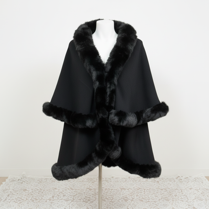 Black cape with fur trim on a mannequin against a white background