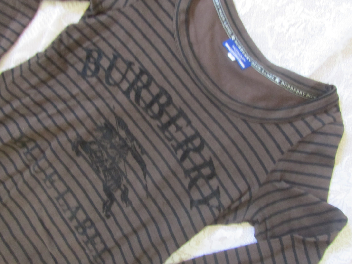 Brown Burberry long-sleeve shirt on a white surface