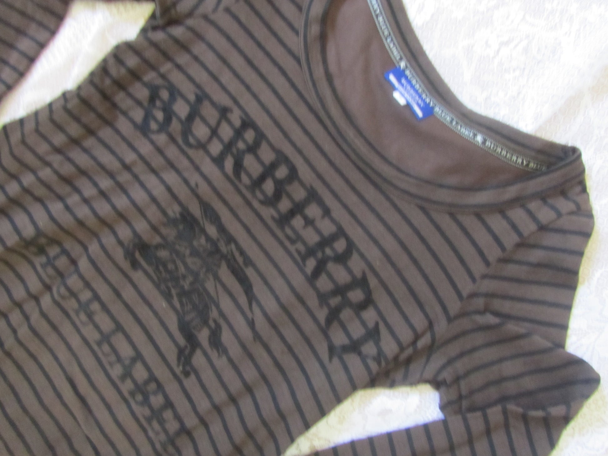 Brown Burberry long-sleeve shirt on a white surface