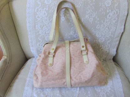 Pink textured handbag with beige straps on a white lace background