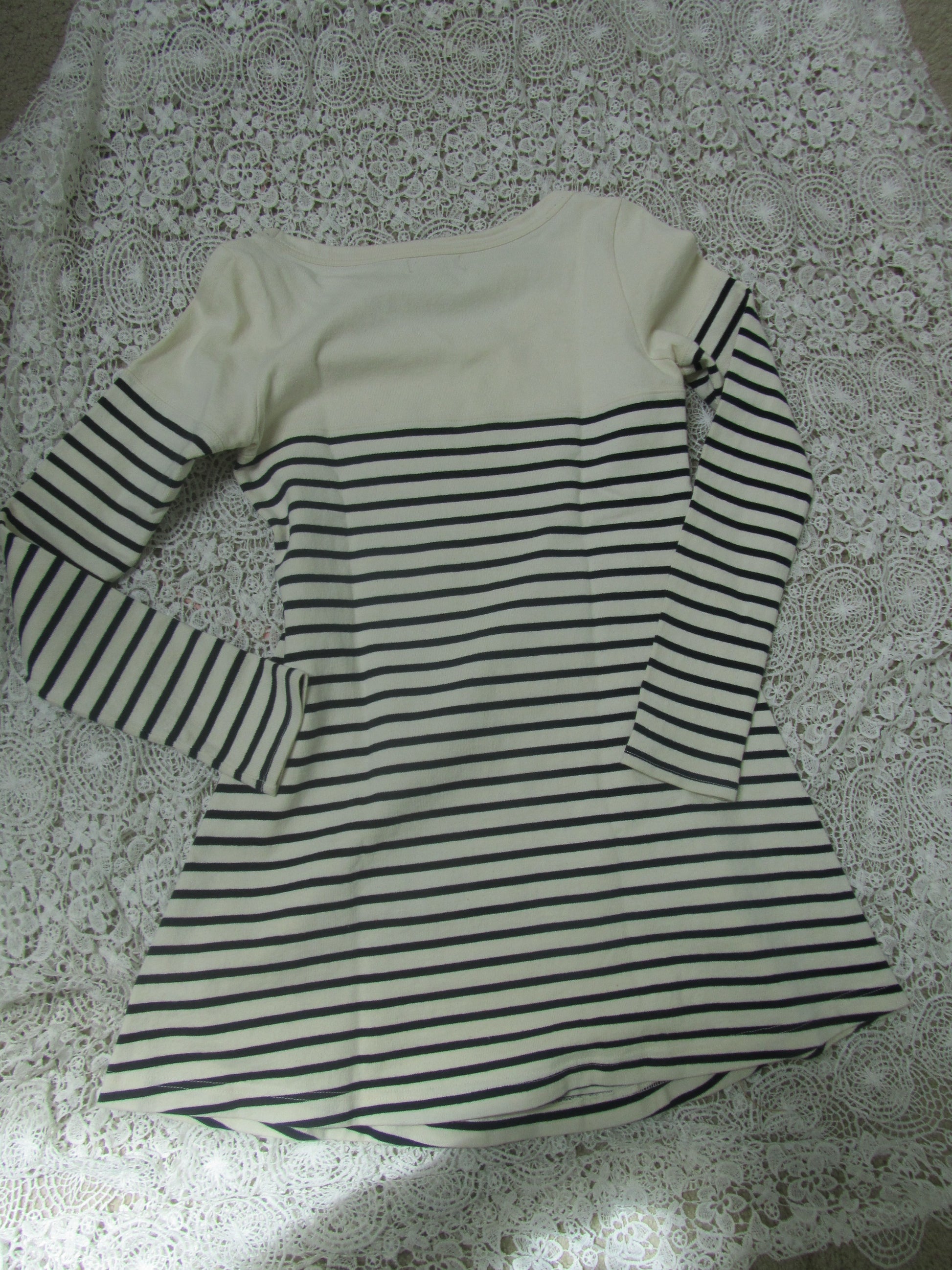 Black and white striped garment on a textured surface