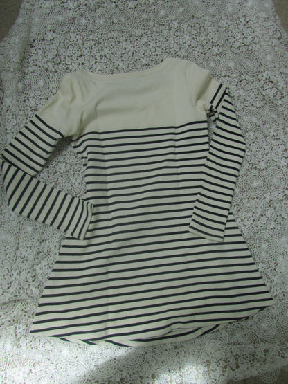 Black and white striped garment on a textured surface