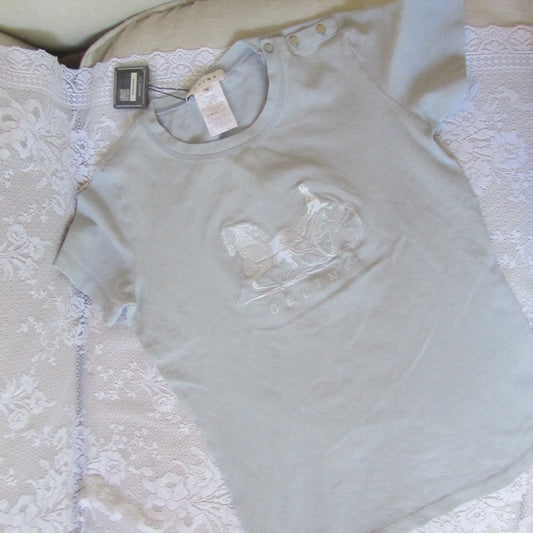 Light gray t-shirt with lace detail on a white surface