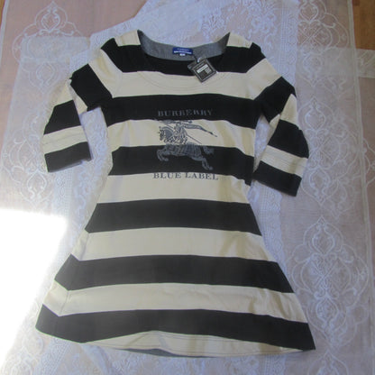 Black and white striped dress with Burberry logo on a lace tablecloth