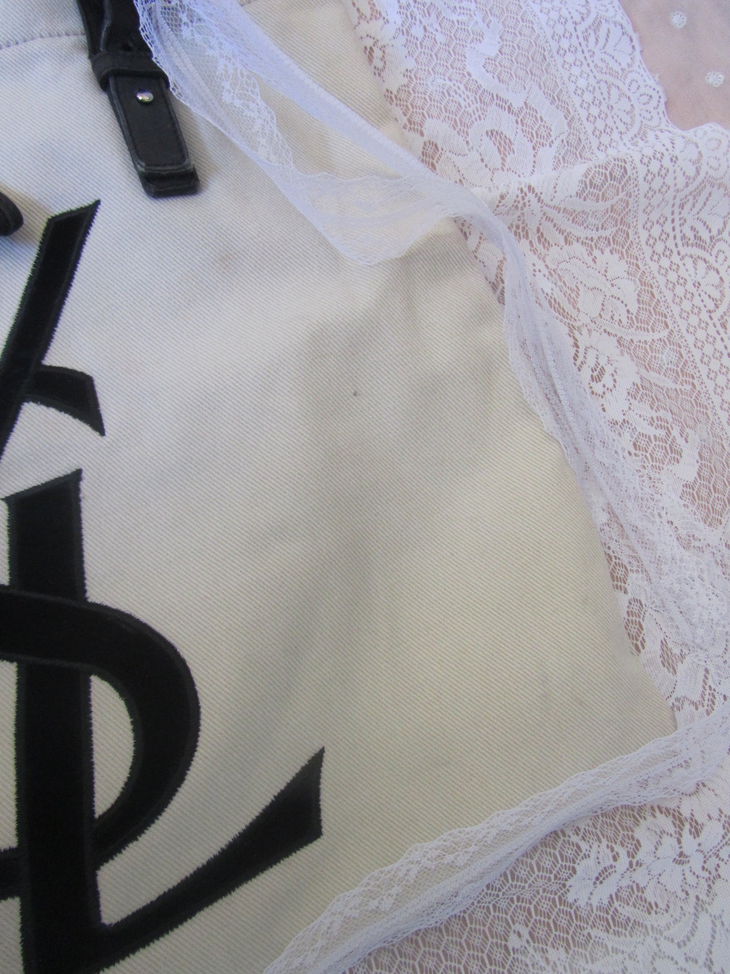 White bag with black text on a lace background