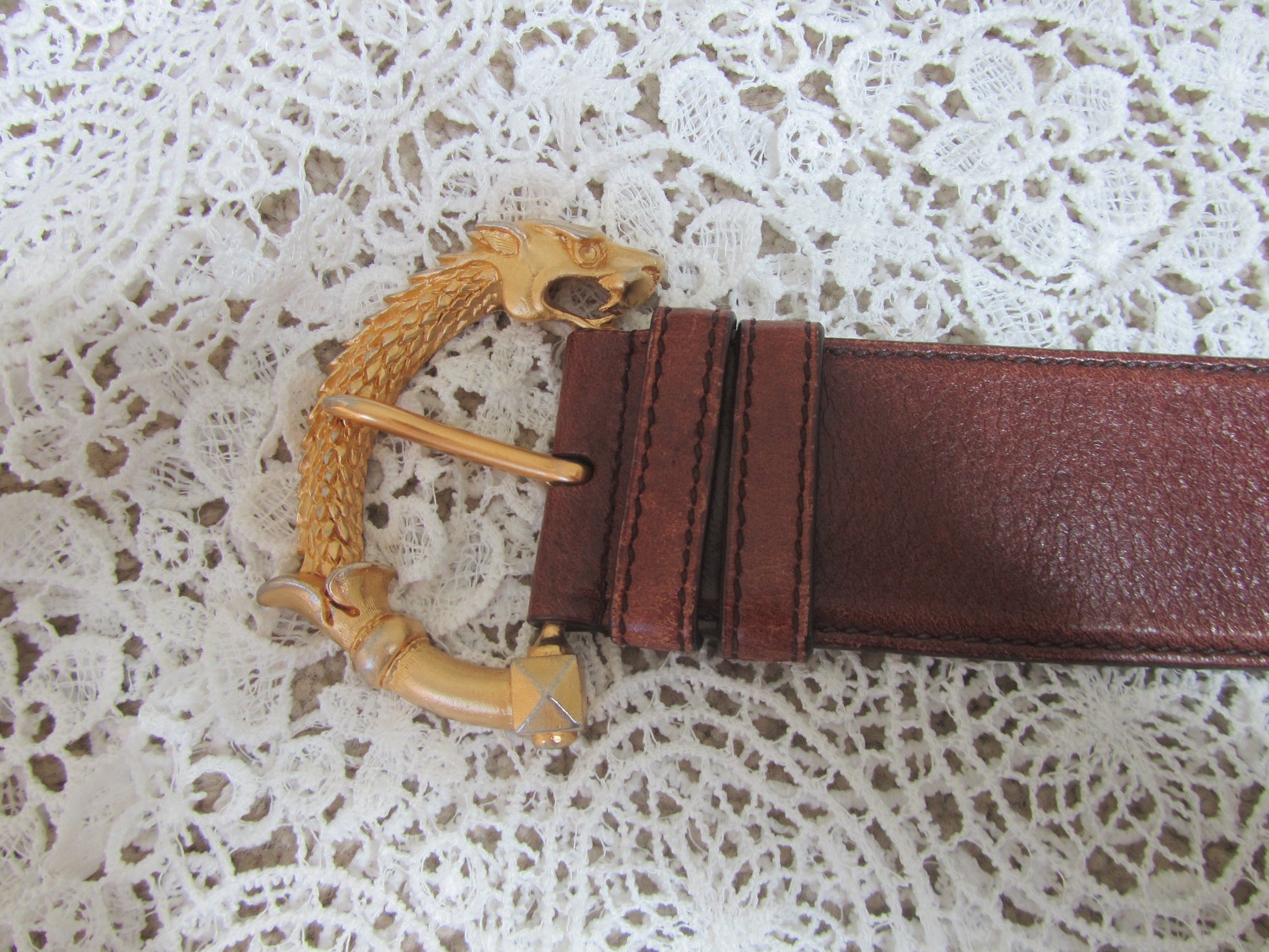 gold belt buckle on lace background