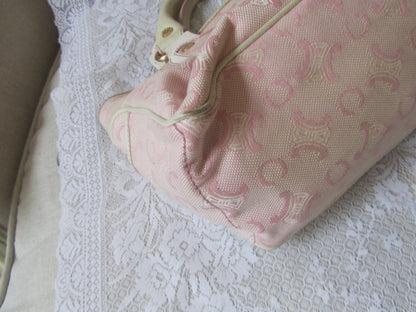 Pink patterned bag on a textured white surface