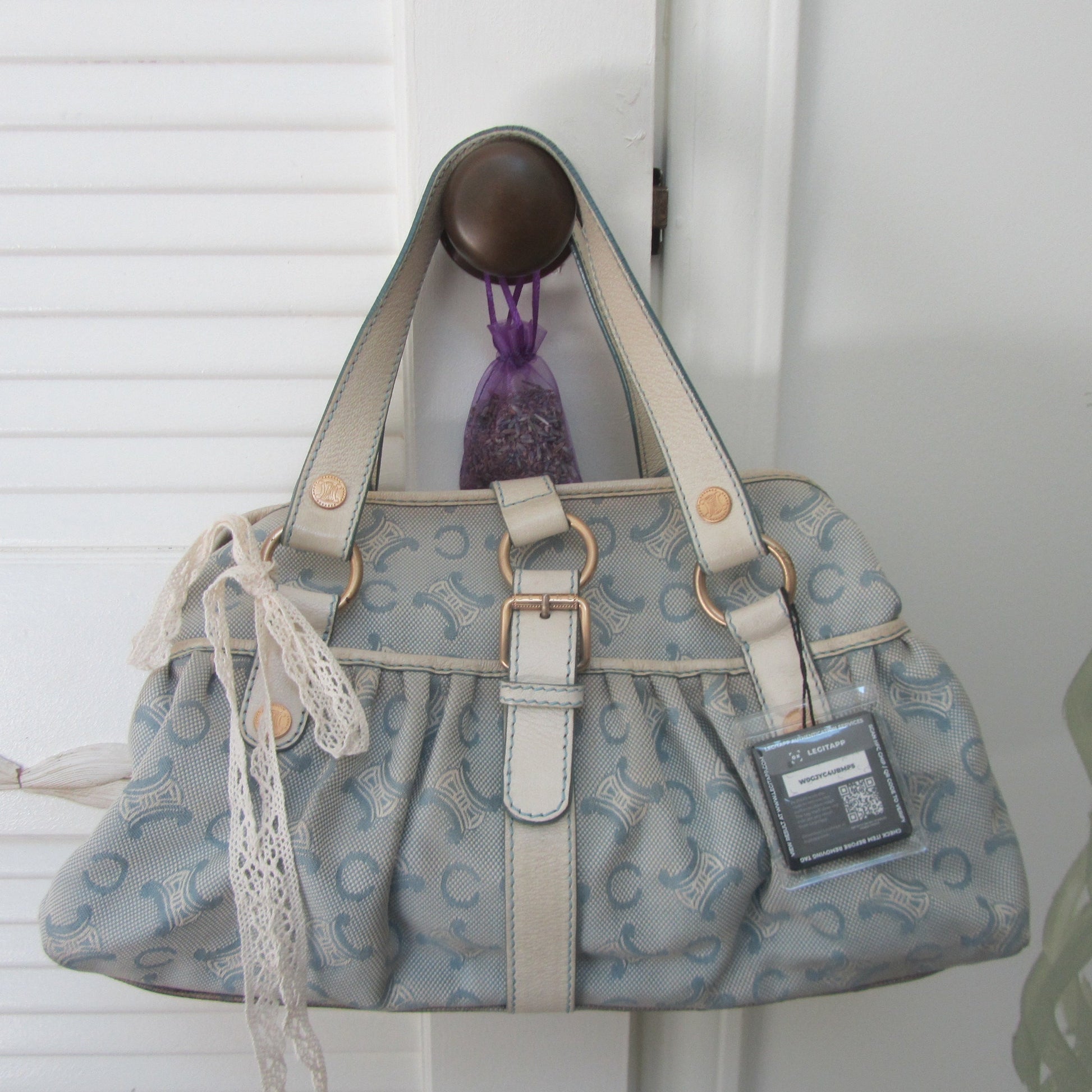 light blue Patterned handbag with a visible brand tag on a white background