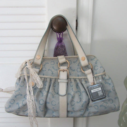 light blue Patterned handbag with a visible brand tag on a white background